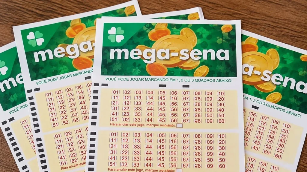 Volantes da Mega-Sena sobre uma mesa de madeira, com o logotipo verde da loteria e quadros de números para apostas.